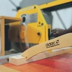 Woodworking machine training course with operator at machinery